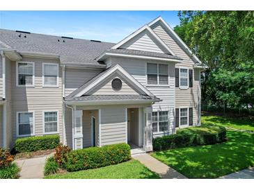 Charming two-story townhome with manicured lawn and inviting entrance at 1300 Eastern Pecan Pl # 104, Winter Garden, FL 34787