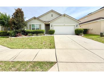 Charming single-story home featuring a well-manicured lawn and attached two car garage at 238 Miniehaha Cir, Haines City, FL 33844