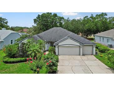 Charming single-story home boasts a well-manicured lawn, mature landscaping, and a three-car garage for ample parking at 468 Alinole Loop, Lake Mary, FL 32746