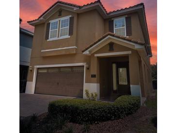 Charming two-story home with a tile roof, an attached two-car garage, and a manicured front yard at 531 Lasso Dr, Kissimmee, FL 34747