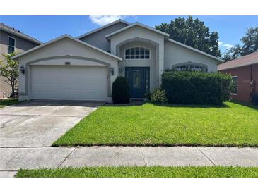 Charming single Gathering home featuring a well-manicured front lawn and a two-car garage at 581 Farmingham Ct, Oviedo, FL 32765