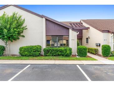 Exterior view of P-6 unit featuring clean landscaping and adjacent parking spaces at 101 Grand Plaza Dr # P6, Orange City, FL 32763
