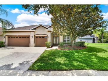 Well-maintained home featuring a three-car garage, lush landscaping, and inviting curb appeal at 1657 Tennyson Ct, Lake Mary, FL 32746