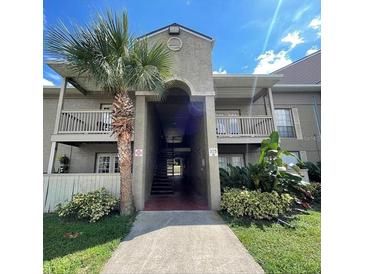 Condo exterior showcasing lush landscaping, and balcony at 315 Wymore Rd # 104, Altamonte Springs, FL 32714