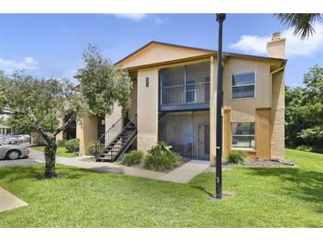 Inviting two-story condo featuring a screened balcony and well-maintained landscaping at 4870 S Semoran Blvd # 1905, Orlando, FL 32822