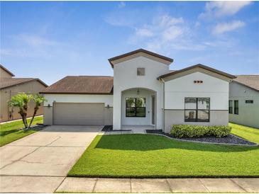Charming single-Gathering home features a well-manicured lawn and attached two-car garage at 921 Costa Mesa Ln, Kissimmee, FL 34744