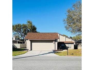 Inviting single-Gathering home featuring a two-car garage and manicured lawn at 1422 Spalding Rd, Winter Springs, FL 32708