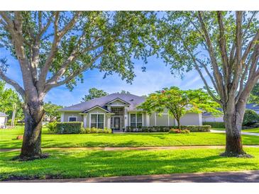 Charming single-story home boasts lush landscaping, mature trees, and inviting curb appeal at 2538 Carter Grove Cir, Windermere, FL 34786