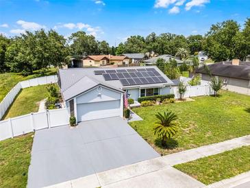 Charming single-story home featuring a solar panel roof, well-manicured lawn, and attached two-car garage at 2832 Buccaneer Dr, Winter Park, FL 32792