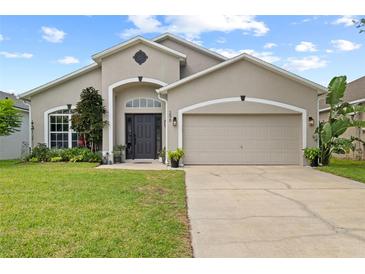 Charming single-story home with a well-maintained lawn and a two-car garage at 298 Clydesdale Cir, Sanford, FL 32773