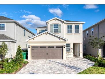 Two-story home features a paved driveway, two-car garage, and neutral exterior paint scheme at 408 Southfield St, Kissimmee, FL 34747