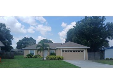 Charming single-story home with a well-manicured lawn and a two-car garage at 439 Lake Daisy Dr, Winter Haven, FL 33884