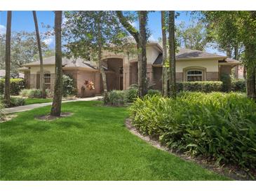 Charming single-Gathering home with lush landscaping and mature trees, offering great curb appeal at 4823 Shoreline Cir, Sanford, FL 32771