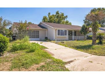Charming single-story home with a concrete driveway and a screened-in garage offers curb appeal at 8426 Sw 114Th St, Ocala, FL 34481