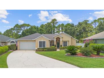 Charming one-story home with a well-manicured lawn, lush landscaping, and a cozy entrance at 3593 Scoutoak Loop, Oviedo, FL 32765