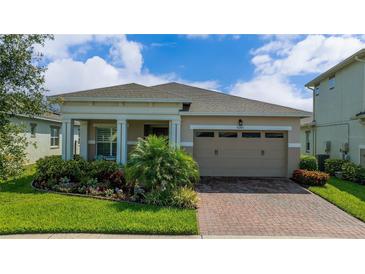 Charming single-story home with a well-manicured lawn and a welcoming two-car garage, fronted by a brick driveway at 5081 Twin Lakes Blvd, St Cloud, FL 34772