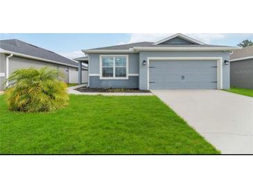 Charming single-Gathering home with a well-maintained lawn and a two-car garage at 141 Sandestin Dr, Haines City, FL 33844