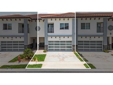 Charming townhouse featuring a garage with glass doors, manicured landscaping, and a stylish modern facade at 2041 Greenbriar Ter, Davenport, FL 33837