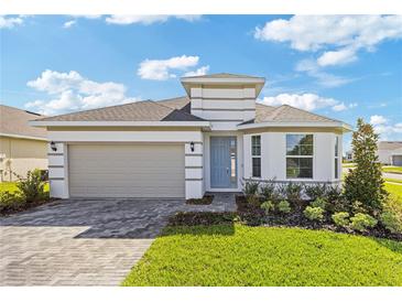 Charming single-Gathering home with a two-car garage, well-maintained lawn, and inviting curb appeal at 2533 Raghav Trl, Tavares, FL 32778