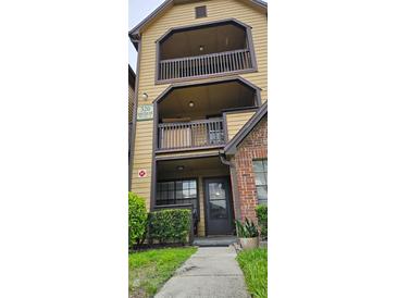 Inviting two-story condo featuring private balconies, brick accents, and well-maintained landscaping at 320 Forestway Cir # 107, Altamonte Springs, FL 32701