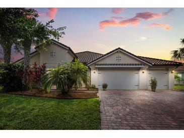 Charming single-story home with a brick driveway and a manicured lawn and garden at 3847 Shoreside Dr, Kissimmee, FL 34746