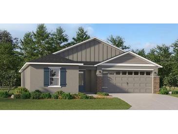 Charming single-Gathering home featuring a two-car garage, well-maintained lawn, and stylish architectural details at 3942 Bigarade Ln, Lake Alfred, FL 33850