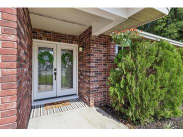 Inviting front entry features double glass doors and colorful flower arrangement at 5436 Tangerine Ave, Winter Park, FL 32792