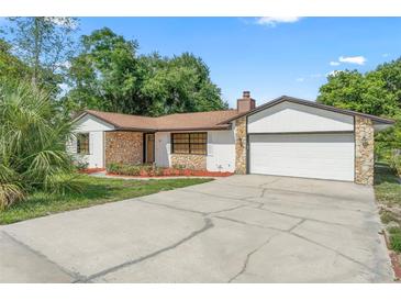 Charming single-story home with a stone accent exterior and a well-manicured lawn at 111 Main St, Windermere, FL 34786