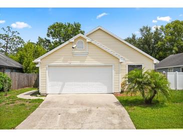 Charming single-story home with a well-maintained lawn and two-car garage, providing a welcoming curb appeal at 189 Lakeside Cir, Sanford, FL 32773