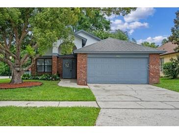 Charming single-Gathering home with a brick facade and mature landscaping in a well-maintained yard at 3107 Ash Park Loop, Winter Park, FL 32792