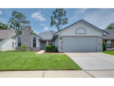 Charming single-story home with a well-maintained lawn, stone accents, and an attached two-car garage at 478 N Sundance Dr, Lake Mary, FL 32746