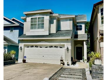 Charming two-story home with a well-manicured lawn, a two car garage, and beautiful stone walkway at 932 S Lake Sterling Ct, Casselberry, FL 32707