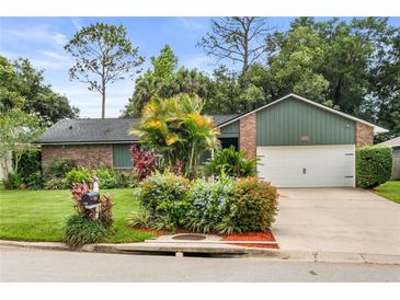 Charming single-story home with brick accents, lush landscaping, and an attached two-car garage at 126 Duncan Trl, Longwood, FL 32779
