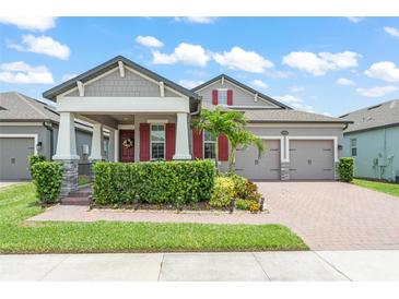 Charming two-story home with a well-manicured lawn, beautiful landscaping, and a cozy front porch at 13227 Spring Grove Way, Winter Garden, FL 34787