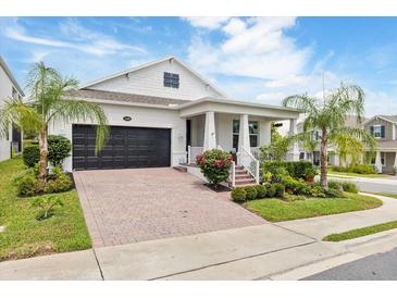 Charming single-Gathering home with a two-car garage, covered front porch, and beautifully landscaped front yard at 1382 Foltz Loop, Oakland, FL 34787