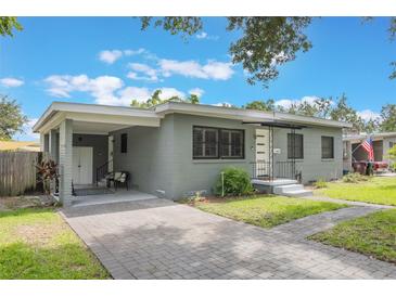 Charming one-story home featuring a brick driveway, covered parking and freshly painted exterior at 2603 E Marks St, Orlando, FL 32803