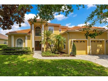 Stunning two-story home with a vibrant yellow facade, manicured lawn, and well-maintained landscaping at 283 Lakay Pl, Longwood, FL 32779