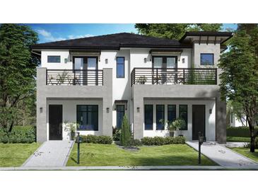 New construction two-story home featuring modern architecture, balconies, and a landscaped front yard at 523 W Princeton St # 1, Orlando, FL 32804