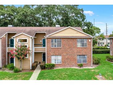 Inviting brick and siding townhouse with lush landscaping and charming curb appeal in a desirable neighborhood at 5545 Devonbriar Way # 206, Orlando, FL 32822