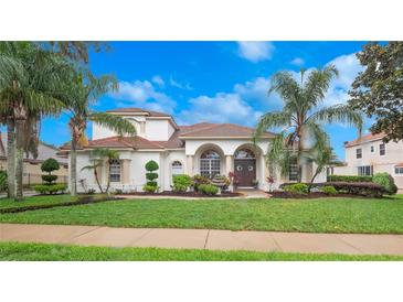 Stunning single-Gathering home with a clay tile roof, lush landscaping, and inviting curb appeal at 8531 Cypress Hollow Ct, Sanford, FL 32771
