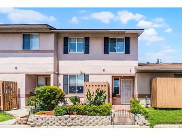 Charming two-story townhome with a well-maintained front yard and garden at 1312 Azalea Way, Winter Garden, FL 34787