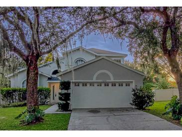 Charming two-story home featuring a two-car garage and mature landscaping at 13200 Mallard Cove Blvd, Orlando, FL 32837