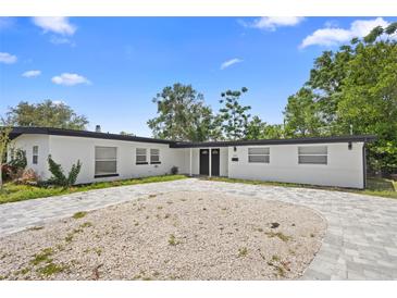 Charming single-story home featuring a neatly paved driveway and lush landscaping at 1511 E Horatio Ave, Maitland, FL 32751