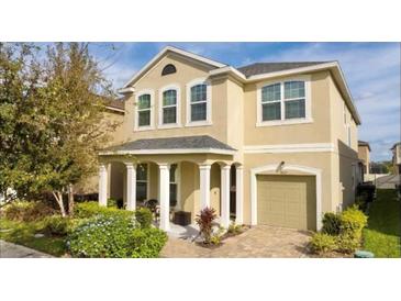 Charming two-story home with manicured landscaping and welcoming front porch at 1625 Nassau Point Trl, Kissimmee, FL 34747