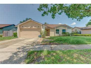 Charming single-story home featuring an attached two-car garage and neutral stucco exterior at 324 Sir Lawrence Dr, Sanford, FL 32773