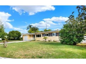 Charming single-story home featuring a well-maintained lawn and attached garage at 4015 Ibis Dr, Orlando, FL 32803