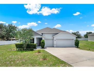 Charming single-Gathering home with a well-manicured lawn, mature landscaping, and a spacious two-car garage at 804 Glen Creek Ct, Fruitland Park, FL 34731