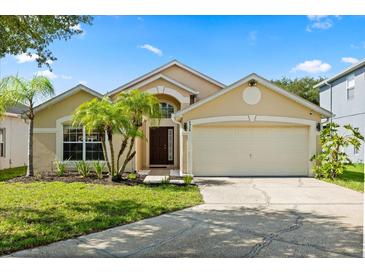 Charming single-Gathering home featuring a two-car garage and well-maintained landscaping with palm trees at 8920 Palisades Beach Ave, Orlando, FL 32829