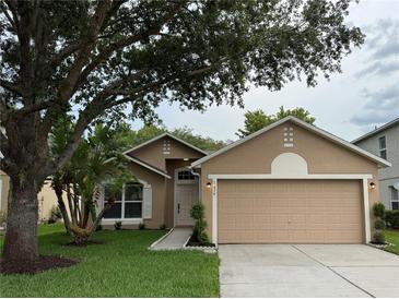 Charming single-story home with a well-maintained lawn, mature trees, and neutral color palette at 1639 Corner Meadow Cir, Orlando, FL 32820
