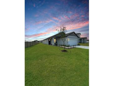 Beautiful single-story home with a well-manicured lawn at sunset at 2707 Virginia Pine Nw Dr, Bartow, FL 33830